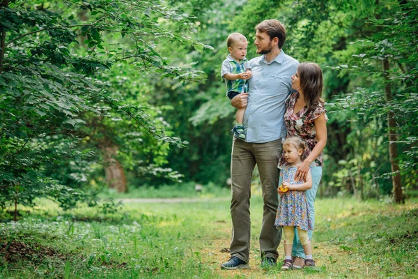 Young happy family walking in the park.