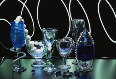 Koyu bir zemin üzerinde mücevher ve bijouterie kompozisyonu. Güzel şarap kadehleri ve deniz kabukları.