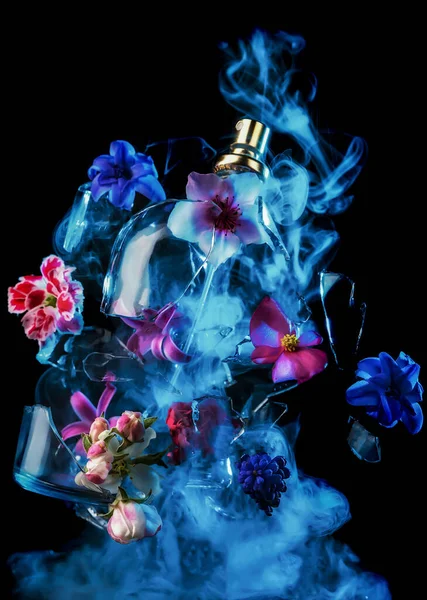 Glass Perfume Bottle Shatters Bright Spring Flowers Clouds Blue Purple — Stock Photo, Image