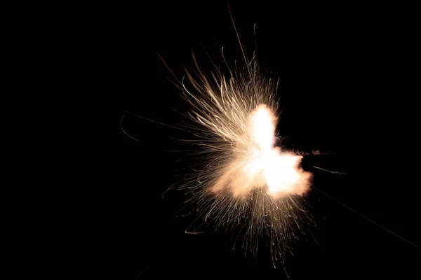 A shot from a firearm on a black background, a fiery exhaust with flying sparks, flames bursting out of the pipe. Fire comes out of the nozzle of a jet engine