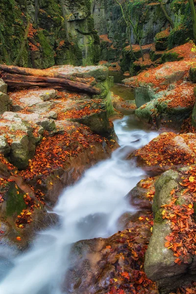Agua que fluye hacia abajo en terreno rocoso montañoso — Foto de Stock