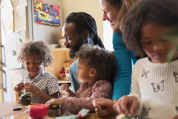 Multiethnic Family Decorating Cupcakes Table — Stock Photo, Image