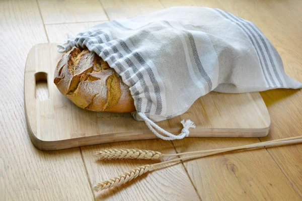 Rolo de pão saboroso no saco de pão de linho reutilizável zero no woode — Fotografia de Stock