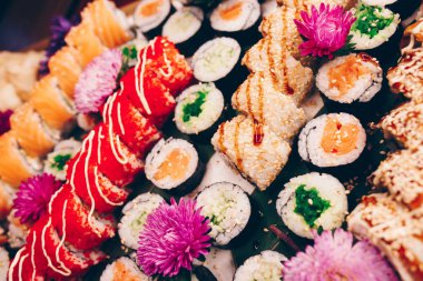 Flat Lay 'den büyük bir lezzetli suşi seti. Geleneksel restoranda bir tabakta Japon çiğ balığından bir sürü Philadelphia dürümü var. Japon yemek menüsü servisi