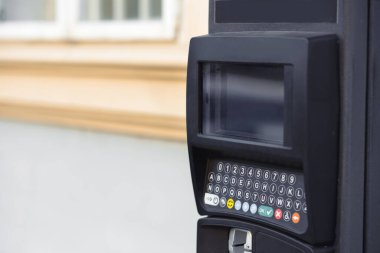 Bir caddedeki modern otomatik ödeme parkmetresi veya bilet ödeme istasyonu, park görevlilerine, araba şoförlerine kredi kartı veya nakit kripto para birimiyle ödeme olanağı sağlıyor..