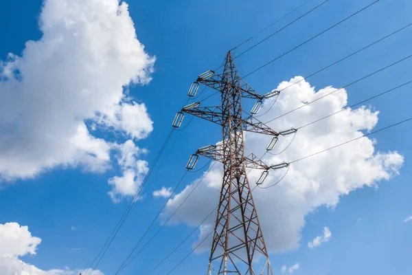 Electricity transmission power lines (High voltage tower) high-voltage lines. Transmission of electricity by means of supports through agricultural areas sunny day with cirrus clouds in the blue sky