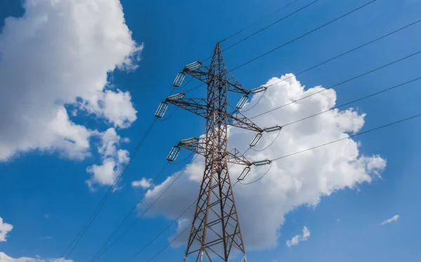 Electricity transmission power lines (High voltage tower) high-voltage lines. Transmission of electricity by means of supports through agricultural areas sunny day with cirrus clouds in the blue sky