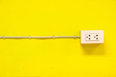 The outlet on yellow wall clipart
