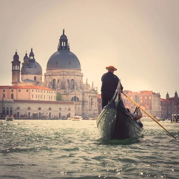 Venetian gondolier in the Grand Canal near the Cathedral of Santa Maria Della Salute