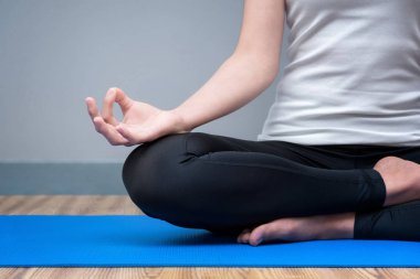 Young woman keep calm and meditates while practicing yoga clipart