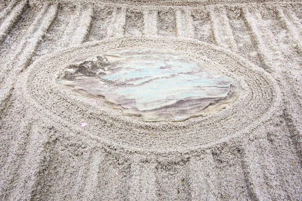 Japanese zen garden meditation stone in lines sand for relaxation