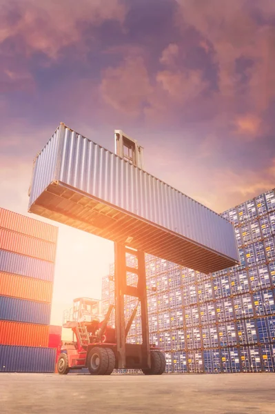 Forklift truck lifting cargo container in shipping yard — Stock Photo, Image