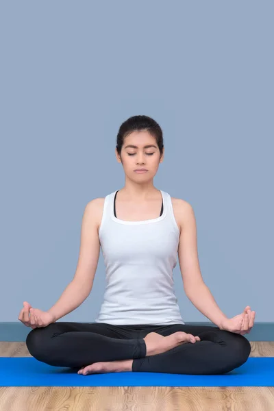 Asian woman keep calm and meditates while practicing yoga to explore the Inner Peace.