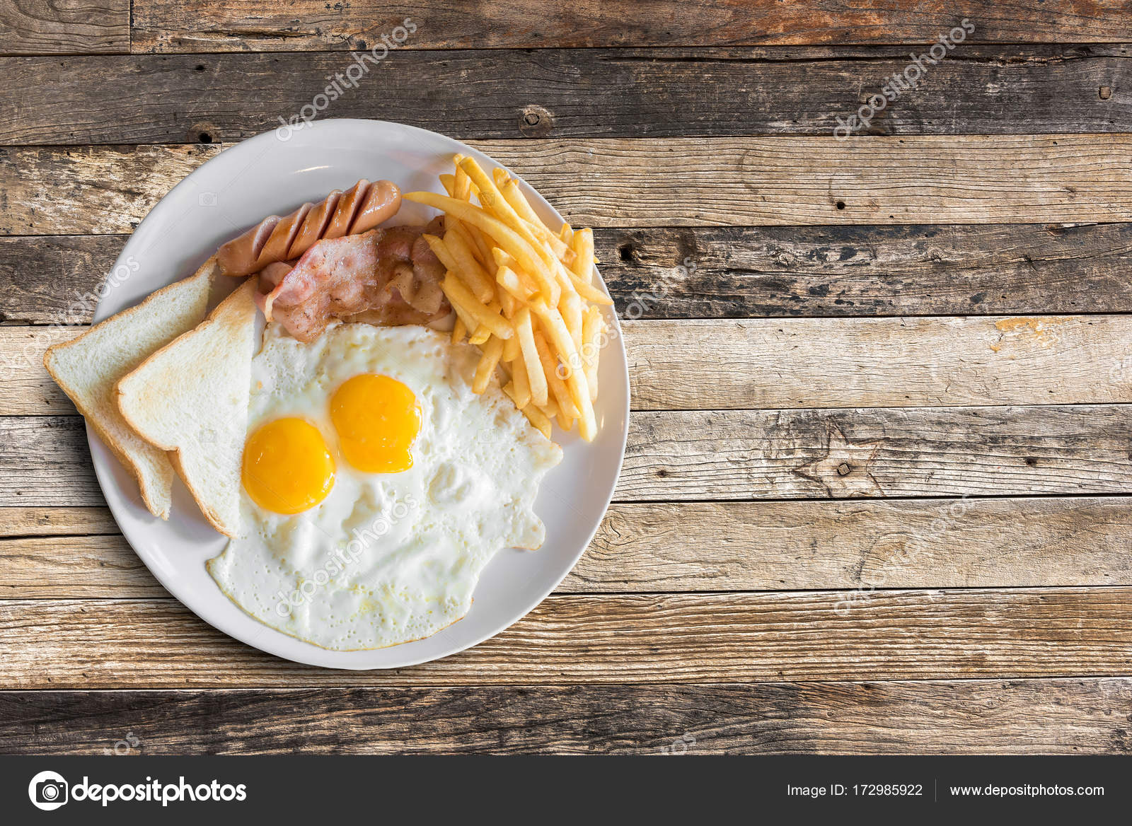 Top View Of American Breakfast With Scrambled Eggs Bacon Toast French Fries And Sausage On Wooden Table Background Stock Photo Image By C Teddybearpicnic