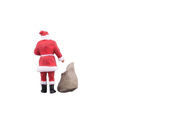 Close up of Miniature Santa Claus and gifts bag isolated with clipping path on white background — Stock Photo, Image