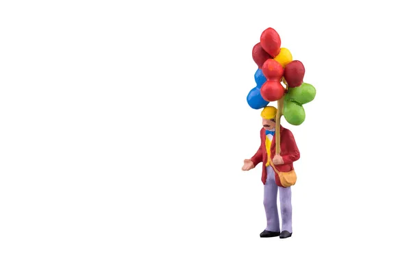 Close up of Miniature people with floating balloon isolated with clipping path on white background — Stock Photo, Image