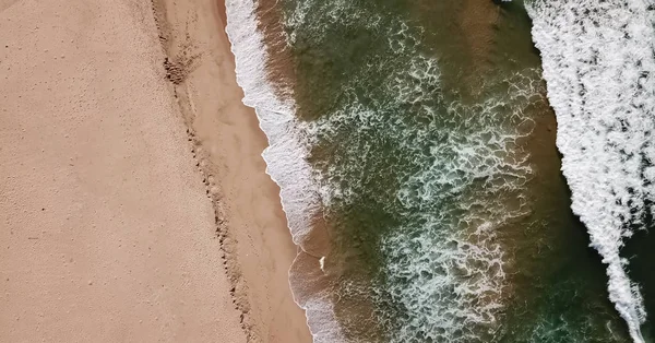 Aerial view, shot with drone on the coast of Angola, water with waves on the beach — Stock Photo, Image