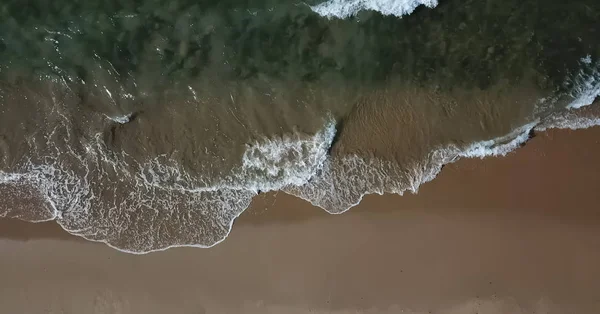 Aerial view, shot with drone on the coast of Angola, water with waves on the beach — Stock Photo, Image