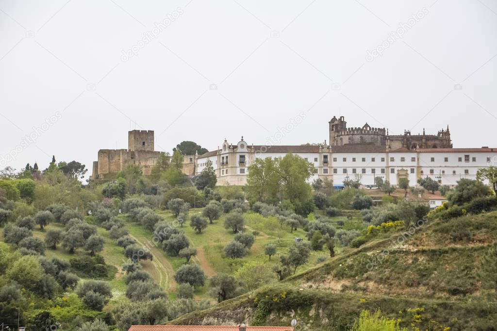 Full view at the Convent of Christ, Roman Catholic convent in Tomar, typical landscape with trees and grass, originally Templar stronghold