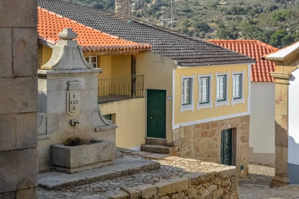 View at the medieval village with detailed fountain, inside fortress castle of Castelo Mendo, plaza and medieval buildings — 스톡 사진