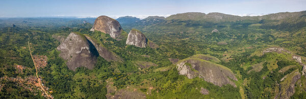 Aerial drone photography of a tropical landscape, with forest and mountains Kumbira forest reserve , huge geologic rock elements, on Conda, Sumbe, Angola