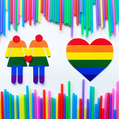 Gökkuşağı arka planında kadın siluetleri ve LGBT kalp