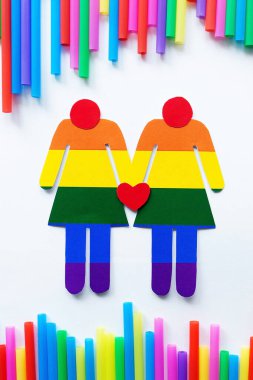 Gökkuşağı arka planında LGBT kadınlarının siluetleri