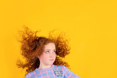 Sarı arka planda kızıl saçlı güzel bir kız, güzel saçlar.