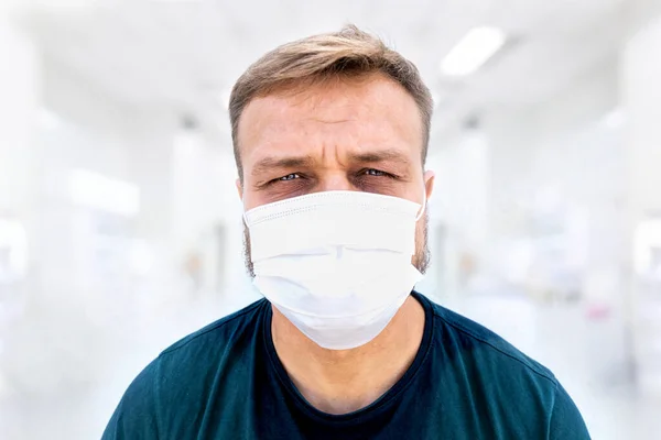 Portrait of caucasian white male doctor, millennial, in medical surgeon face mask and sweaty short. Coronavirus outbreak, medical personal fatigue and tiredness.