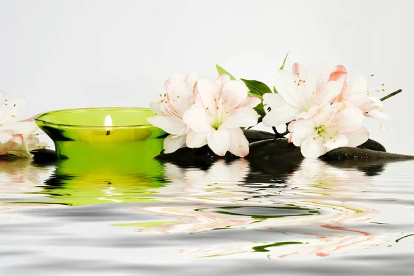 Kerzen, Blumen und Steine auf dem Wasser in der Therme — Stockfoto