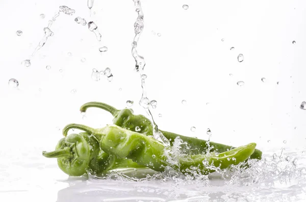 fresh green peppers with splashes of water