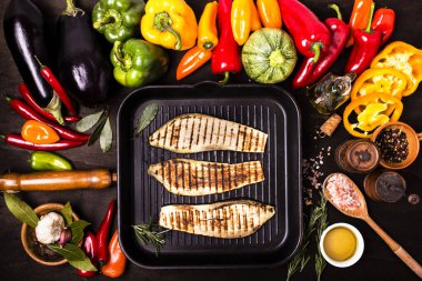 Tahta masada, yukarıdan manzaralı, tavada taze ve ızgara sebzeler var.