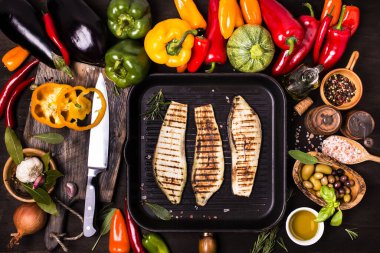 Tahta masada, yukarıdan manzaralı, tavada taze ve ızgara sebzeler var.