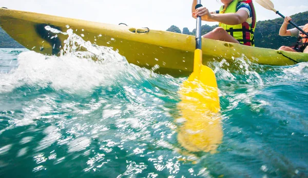 Close of explorer women in life jacket paddling hard kayak. — Stock Photo, Image