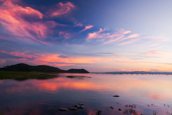 Dramatic twilight sky above a tropical lake.