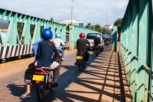 Laotians pessoas andando de motos e carros de condução através da velha ponte de aço verde . — Fotografia de Stock