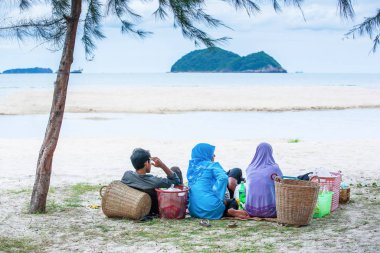 Muslim family picnicking on the beach.