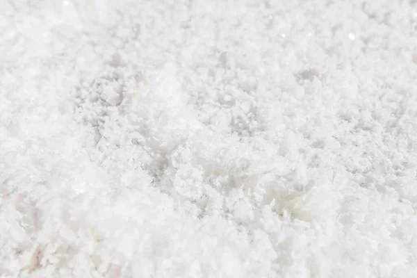 Pure white crystal salt on the table, pure white crystal salt or rock salt. Full frame. Flat lay. Top view. Close-up.