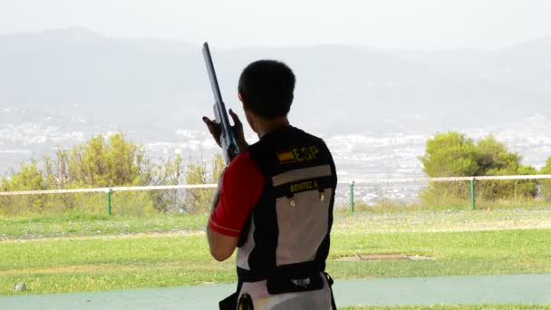 Shooter homem apontando e disparando um rifle em skeet competitio — Vídeo de Stock