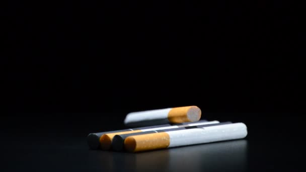 Cigarettes tobacco rotating on black background — Stock Video