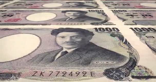 Banknoten im Wert von tausend Yen japanische Rollen auf dem Bildschirm, Bargeld, Schleife — Stockvideo