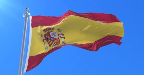 Spain flag waving at wind with blue sky in slow, loop — Stock Video