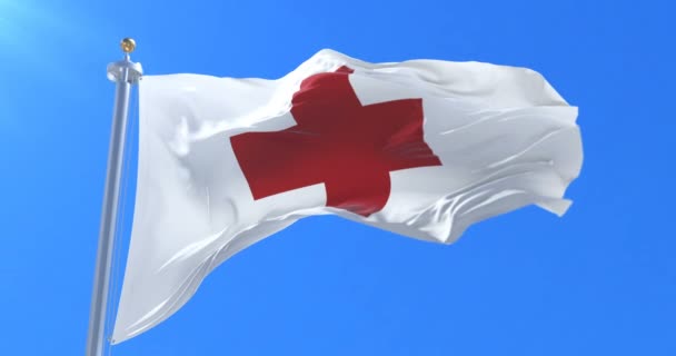 Bandera de la Cruz Roja Internacional ondeando al viento lentamente con el cielo azul, bucle — Vídeos de Stock