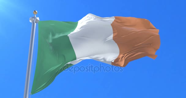 Flag of Ireland waving at wind in slow in blue sky, loop — Stock Video