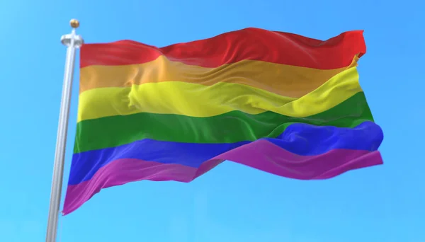 The rainbow flag, LGBT pride flag or gay pride flag waving at wind