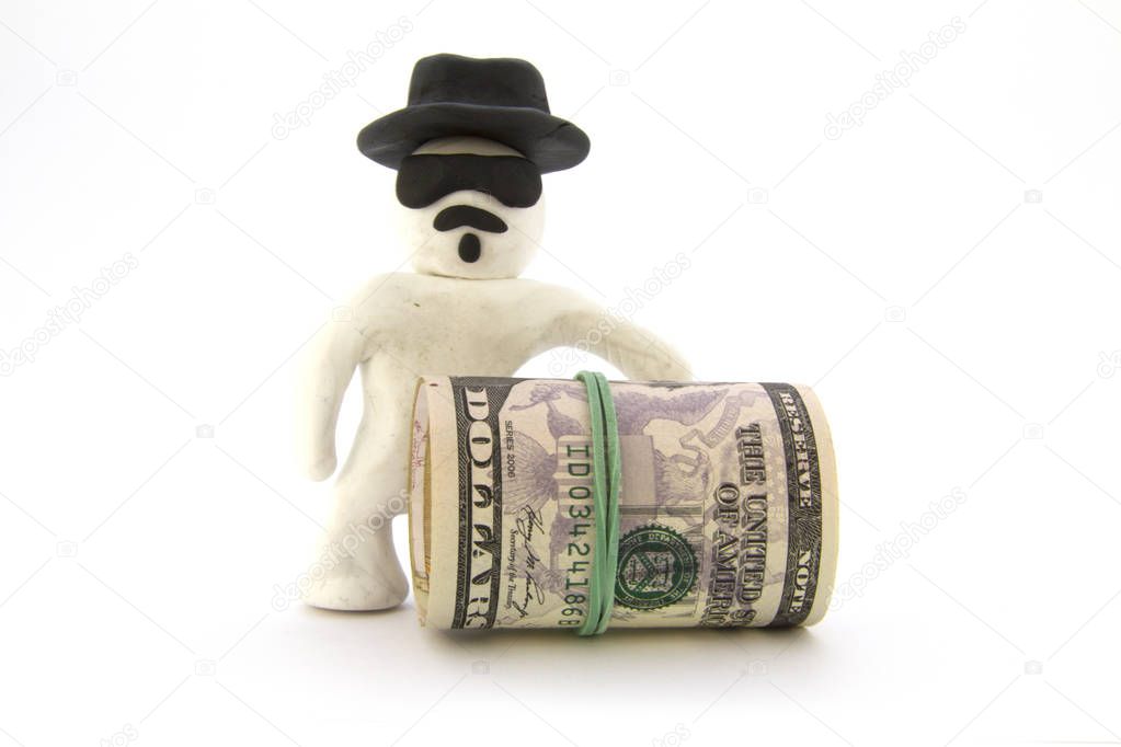 White plasticine character (Heisenberg) and ready cash dollars. Isolated on white background