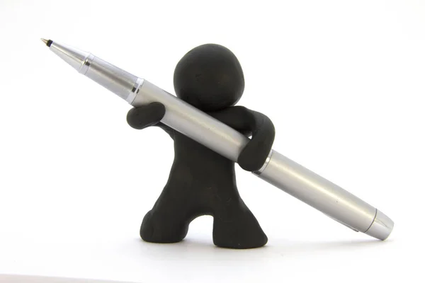 Black plasticine character and silver ballpoint pen. Stationery. Isolated over white background — Stock Photo, Image