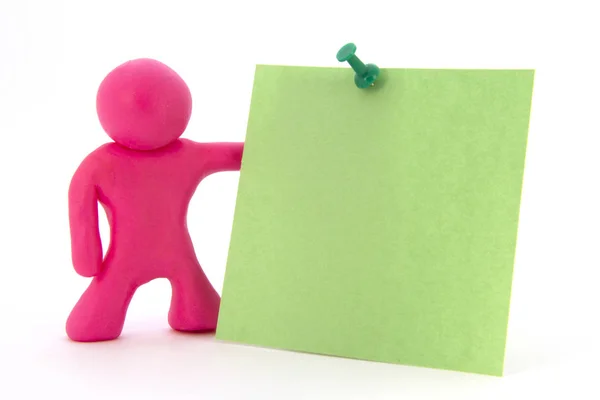 Roze plasticine karakter en groene sticker. Briefpapier. Geïsoleerd op witte achtergrond — Stockfoto