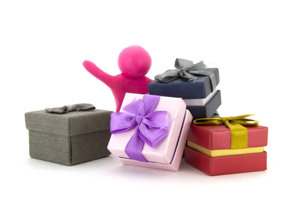 Pink plasticine character and gift boxes on white background. Present boxes. Holidays concept. — Stock Photo, Image