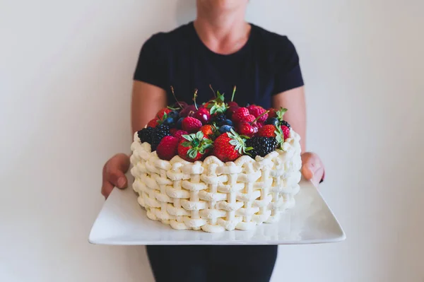 Woman Holding Plate Beautiful Summer Cake Decorated Berries White Wall — Stock Photo, Image